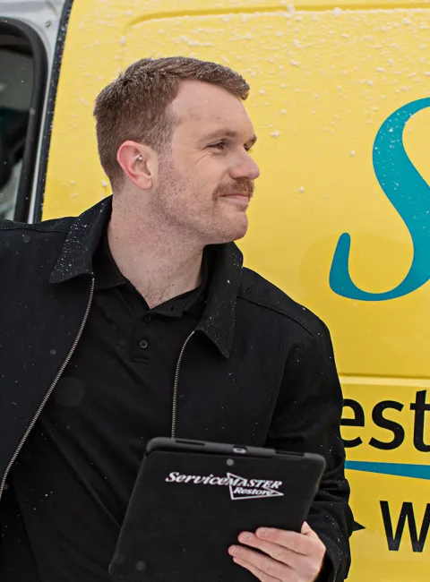 ServiceMaster Restore employee getting out of van