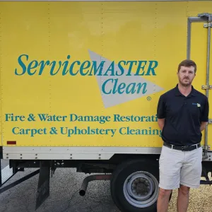 Carson Middleton standing by his ServiceMaster production truck