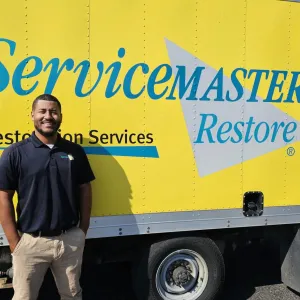 Darius Goins standing by his ServiceMaster production truck
