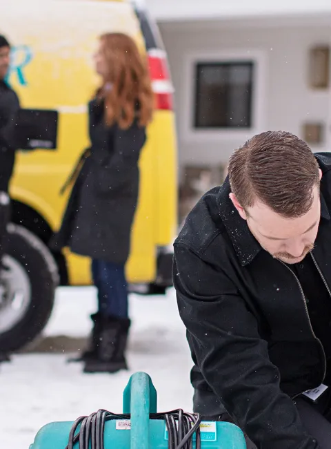 ServiceMaster Restore employee getting equipment ready in snow