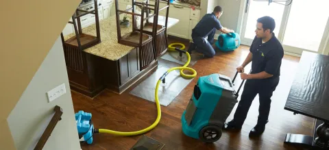 Winnetka Water Damage Restoration - two ServiceMaster Restoration By Simons techs begin drying a kitchen affected by water
